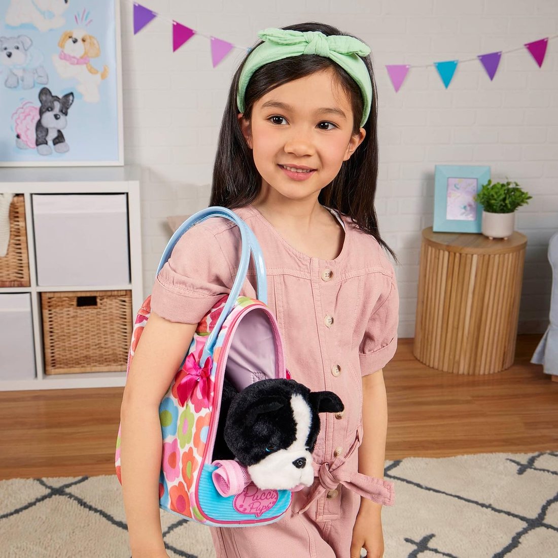 A girl carrying a Pucci Pups floral bag with a Boston Terrier peeking out